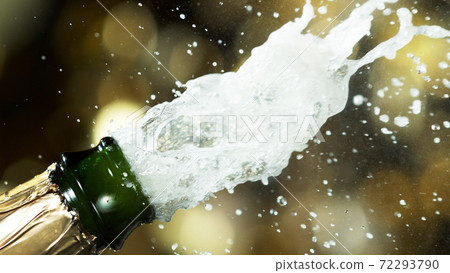 Detail of champagne wine splashing from bottle 72293790