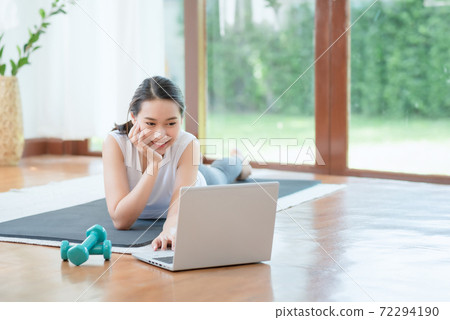 Beautiful asian woman staying fit by exercising at home for healthy trend lifestyle 72294190