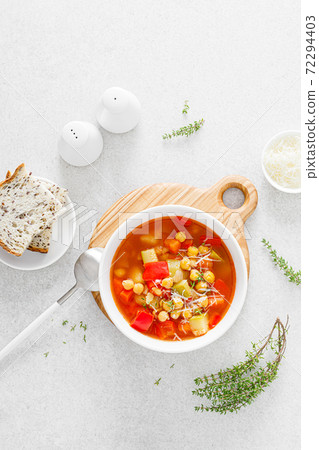 Tuscan tomato chickpea soup with various vegetables, thyme and parmesan cheese, top view Tuscan tomato chickpea soup with various vegetables, thyme and parmesan cheese, top view 72294403