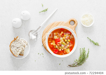 Tuscan tomato chickpea soup with various vegetables, thyme and parmesan cheese, top view Tuscan tomato chickpea soup with various vegetables, thyme and parmesan cheese, top view 72294404