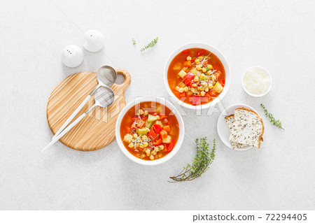 Tuscan tomato chickpea soup with various vegetables, thyme and parmesan cheese, top view Tuscan tomato chickpea soup with various vegetables, thyme and parmesan cheese, top view 72294405