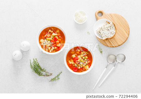Tuscan tomato chickpea soup with various vegetables, thyme and parmesan cheese, top view Tuscan tomato chickpea soup with various vegetables, thyme and parmesan cheese, top view 72294406