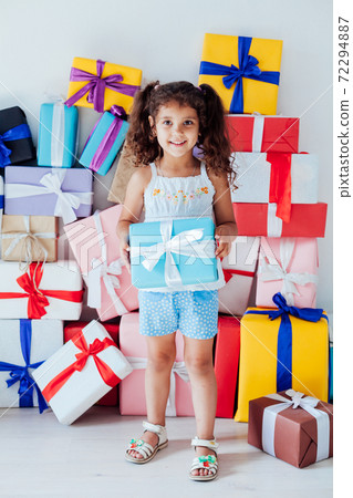 Beautiful little girl a lot of gifts for birthday celebration Beautiful little girl a lot of gifts for birthday celebration 72294887