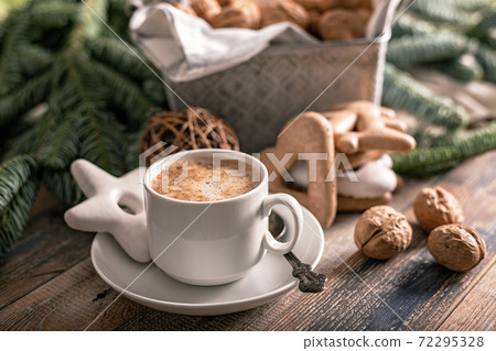 Hot flavored nutty cappuccino with caramel and gingerbread Christmas cookies on a rustic table. Homemade sweet pastries Hot flavored nutty cappuccino with caramel and gingerbread Christmas cookies on a rustic table. Homemade sweet pastries 72295328