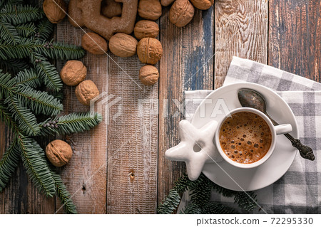 Hot nutty cappuccino with caramel and gingerbread Christmas cookies on a rustic table. Homemade sweet pastries. Top view. Copy space Hot nutty cappuccino with caramel and gingerbread Christmas cookies on a rustic table. Homemade sweet pastries. Top view. Copy space 72295330