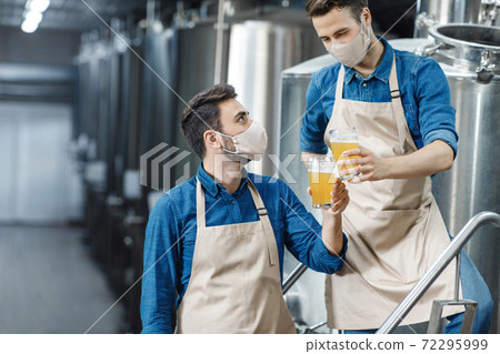 Tasting and checking drink at plant during coronavirus quarantine Tasting and checking drink at plant during coronavirus quarantine 72295999