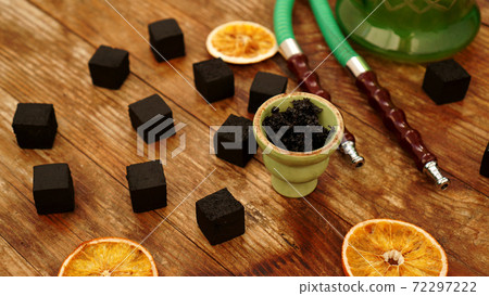 Tobacco in the bowl for hookah on wooden background 72297222