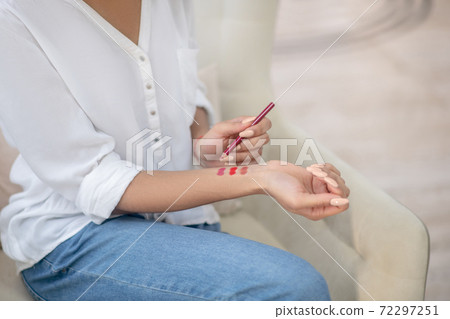 Woman trying different tones of red lip pencil Woman trying different tones of red lip pencil 72297251