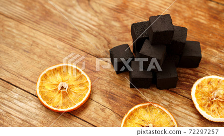 Coals for hookah on wooden background 72297257