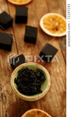 Tobacco in the bowl for hookah on wooden background. Vertical photo Tobacco in the bowl for hookah on wooden background. Vertical photo 72297293