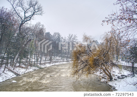 Passer river and its promenade in Merano, Italy covered by snow. 72297543
