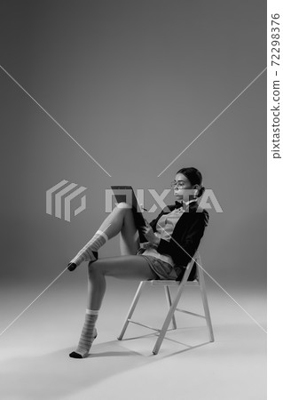Young fashionable, stylish woman wearing jacket and socks working from home. Fashion during insulation 'cause of coronavirus pandemic Young fashionable, stylish woman wearing jacket and socks working from home. Fashion during insulation 'cause of coronavirus pandemic 72298376