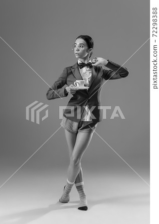 Young fashionable, stylish woman wearing jacket and socks working from home. Fashion during insulation 'cause of coronavirus pandemic 72298388