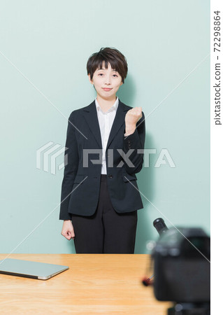 Young woman doing a guts pose looking at the camera 72298864