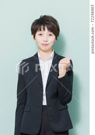 Young woman doing a guts pose looking at the camera 72298865