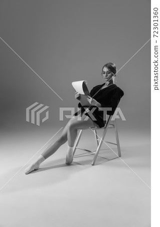 Young fashionable, stylish woman wearing jacket and socks working from home. Fashion during insulation 'cause of coronavirus pandemic Young fashionable, stylish woman wearing jacket and socks working from home. Fashion during insulation 'cause of coronavirus pandemic 72301360