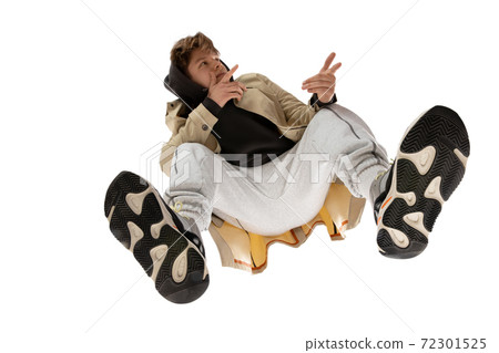 Young stylish man in modern street style outfit isolated on white background, shot from the bottom 72301525