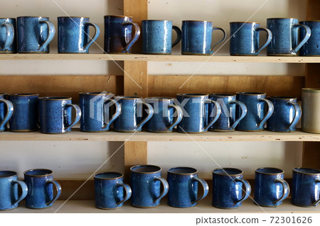a display case is a display of dishes and kitchen utensils in a large store in Israel	 72301626