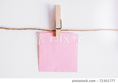 Pink stickers on clothesline with wooden clothespin isolated on white background. Place for your text Pink stickers on clothesline with wooden clothespin isolated on white background. Place for your text 72301777