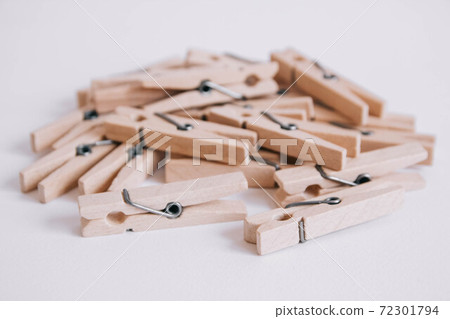 Wooden clothespins scattered on a white background. Copy space 72301794