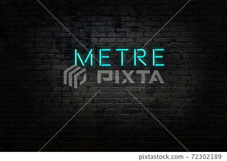 Night view of neon sign on brick wall 72302189