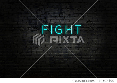 Night view of neon sign on brick wall 72302190
