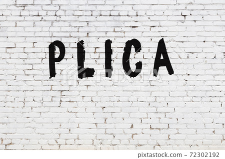 Word plica painted on white brick wall Word plica painted on white brick wall 72302192