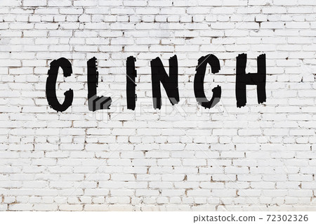 Word clinch painted on white brick wall 72302326