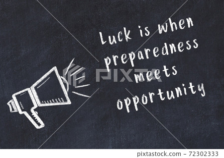 Chalk loudspeaker and wise quote on black desk Chalk loudspeaker and wise quote on black desk 72302333