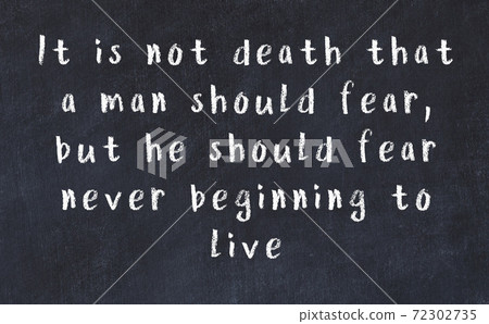 Chalk wise inscription on black chalkboard 72302735