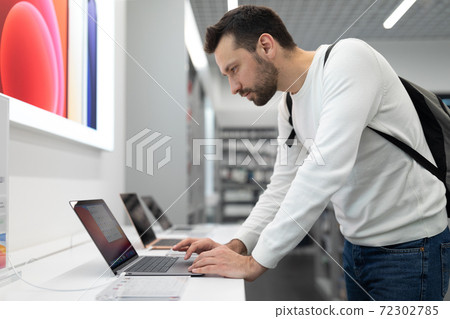 Belarus; December 05, 2020; a man chooses a gift for a holiday in an epl brand store, looks at a Belarus; December 05, 2020; a man chooses a gift for a holiday in an epl brand store, looks at a 72302785