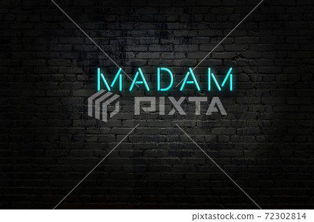 Night view of neon sign on brick wall 72302814