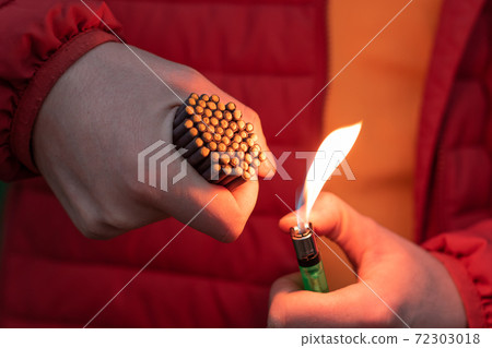 Man in Red Jacket Lighting Up Many Small Firecrackers 72303018