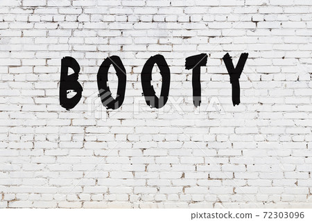 Word booty painted on white brick wall 72303096