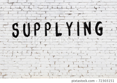 Word supplying painted on white brick wall 72303151
