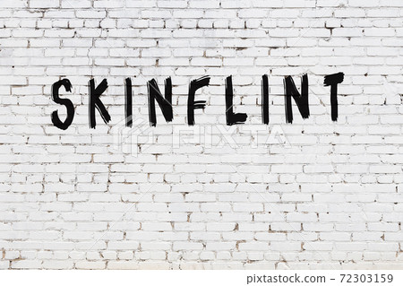Word skinflint painted on white brick wall Word skinflint painted on white brick wall 72303159