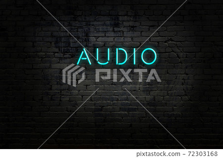 Night view of neon sign on brick wall 72303168