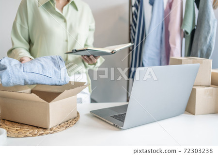 Business owner entrepreneur packing cardboard box preparing parcel for shipment, Online marketing.. Business owner entrepreneur packing cardboard box preparing parcel for shipment, Online marketing.. 72303238