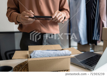 Business owner entrepreneur packing cardboard box preparing parcel for shipment, Online marketing.. Business owner entrepreneur packing cardboard box preparing parcel for shipment, Online marketing.. 72303239