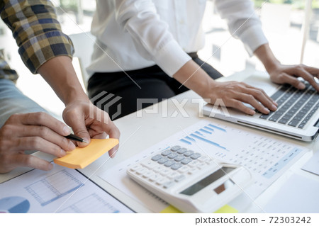 Business Startup team discussing on data report documents at modern workplace.. 72303242