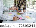 Startup business people teamwork calculating a valuation in workplace.. 72303243