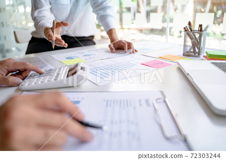 Business Startup team discussing on data report documents at modern workplace.. 72303244