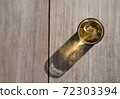 A cup of beer and ice on wooden table with sunlight and shadow. 72303394