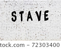 Word stave painted on white brick wall 72303400