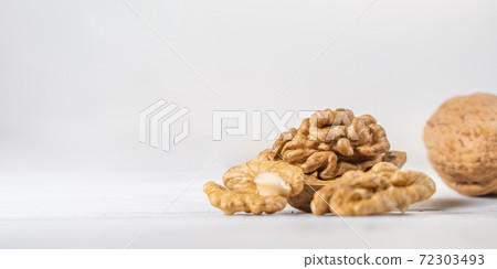 Walnuts kernels on white wooden desk, stock photo Walnuts kernels on white wooden desk, stock photo 72303493