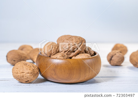 Walnuts kernels on white wooden desk, stock photo Walnuts kernels on white wooden desk, stock photo 72303497