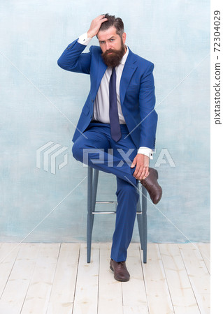 Confident and stylish. Classy hipster sit on chair. Bearded  72304029