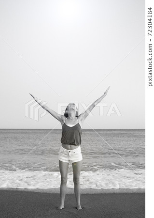 Young woman on the beach in very positive and happy attitude Young woman on the beach in very positive and happy attitude 72304184