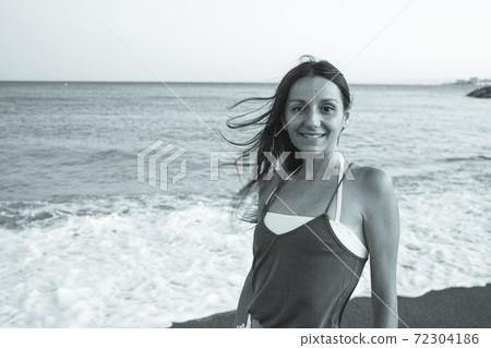 Young woman on the beach in very positive and happy attitude Young woman on the beach in very positive and happy attitude 72304186