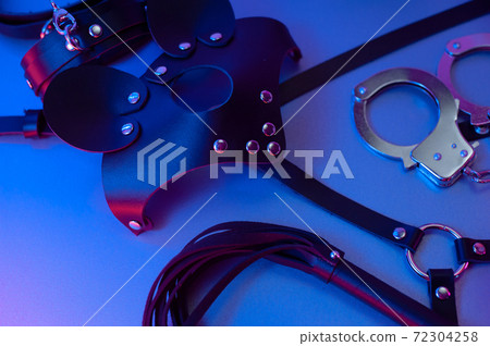 Set of erotic toys for BDSM. The game of sexual slavery with a whip, gag and leather blindfold. Intimate sex games 72304258